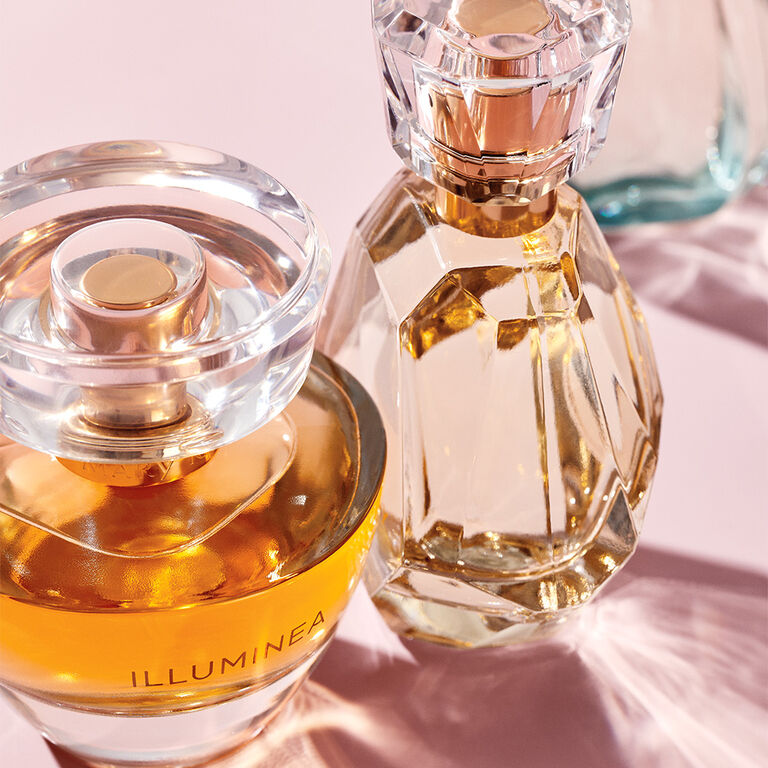 Assorted Mary Kay fragrance bottles in various shapes and colors arranged in a stylish composition.