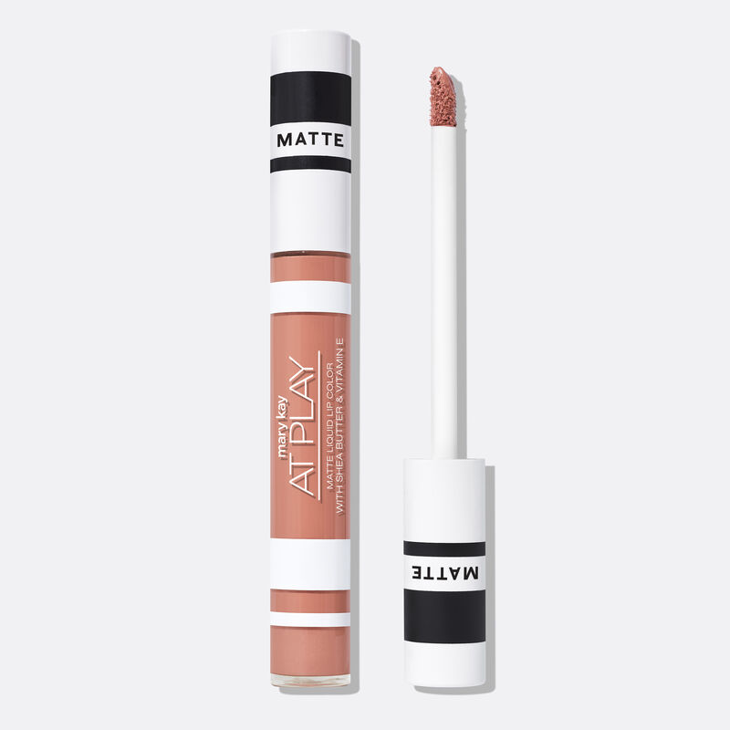 Closed tube of Mary Kay At Play Matte Liquid Lip Color in shade Peach Party next to accompanying applicator