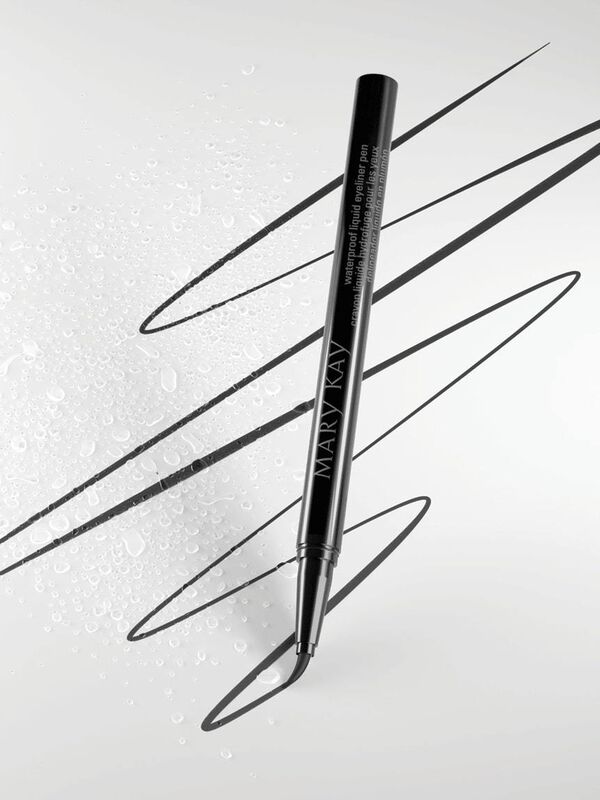 Mary Kay Waterproof Liquid Eyeliner Pen drawing lines against a gray background with water droplets.