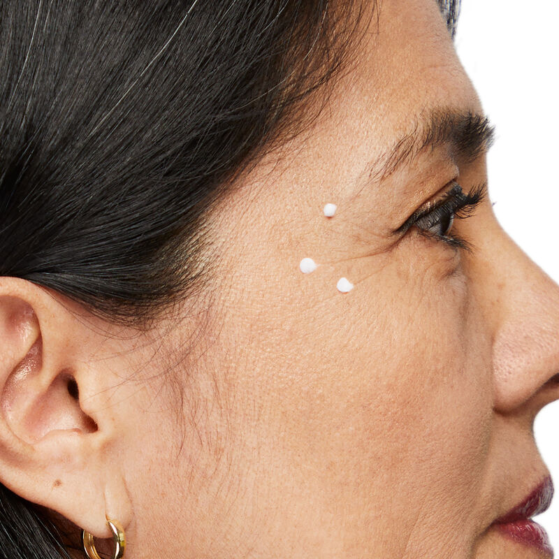 Close-up image of Dynamic Wrinkle Limiter placed in dots along extended crow&rsquo;s feet of mature brunette woman