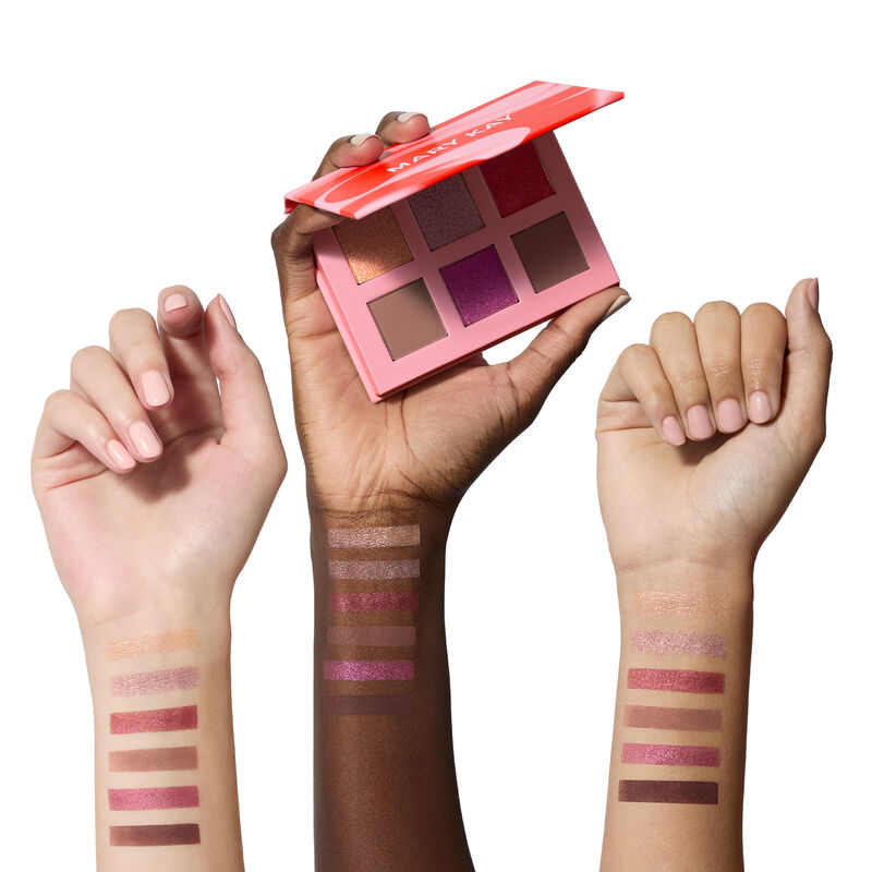 Swatches of all six colors from the limited-edition Mary Kay Eye Shadow Palette in Outer Glow on light, deep and medium skin-toned arms against white 