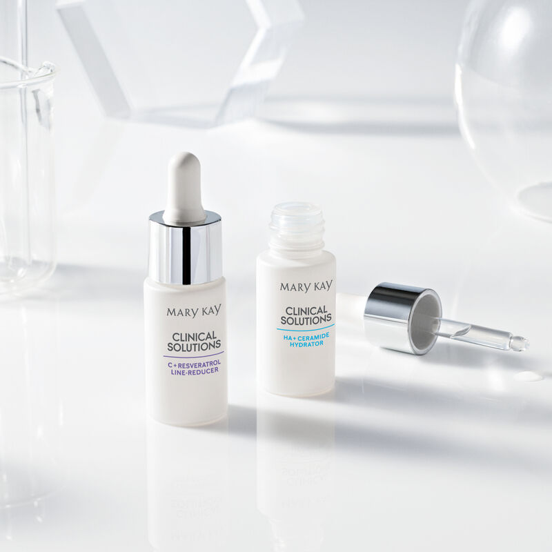 Closed bottle of Mary Kay Clinical Solutions C + Resveratrol Line-Reducer and open bottle of Mary Kay Clinical Solutions&trade; HA + Ceramide Hydrator