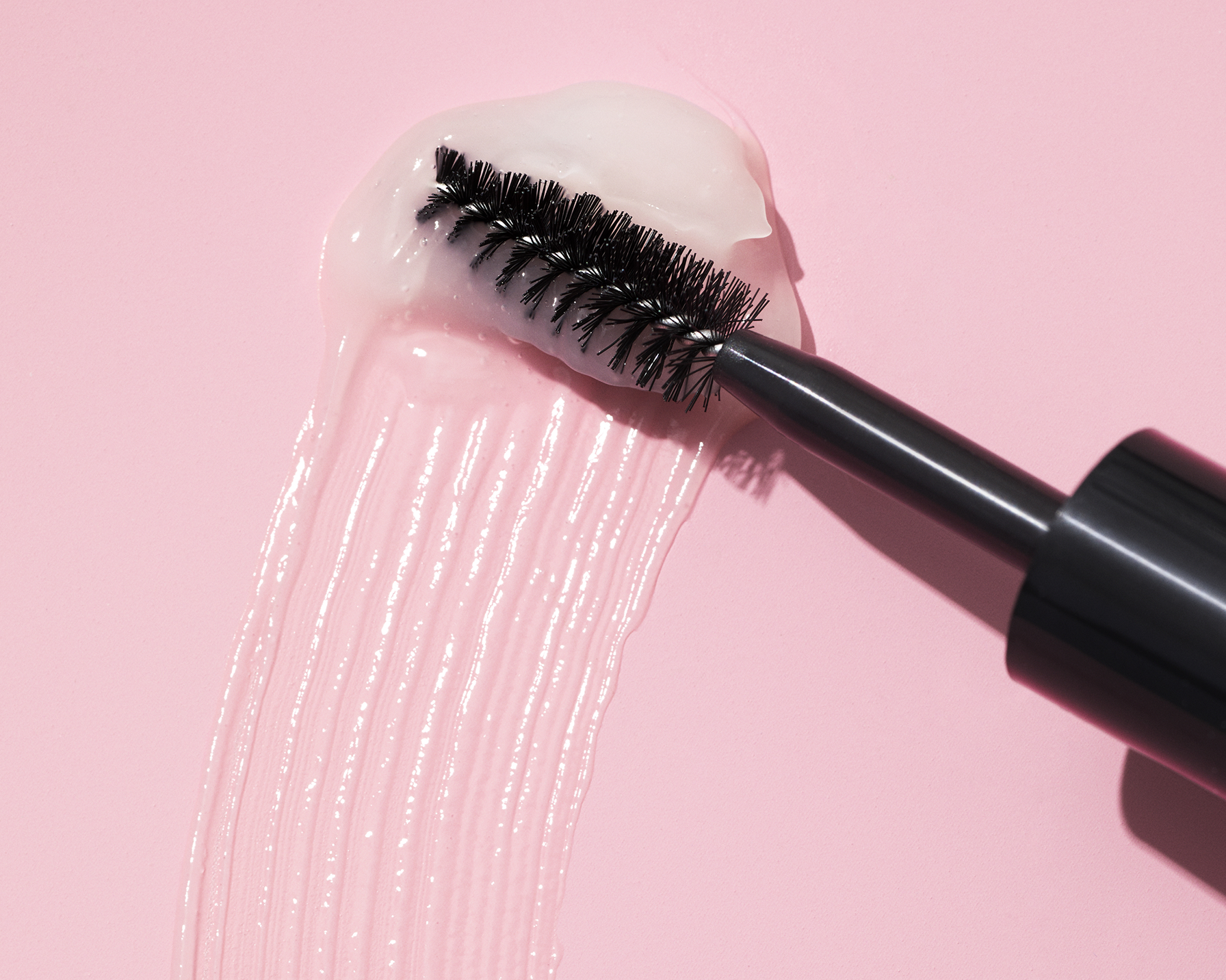A close up of a woman's face with eye cream.