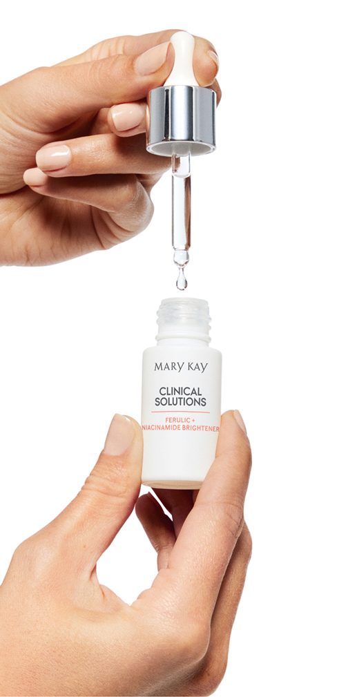 Model holding Mary Kay Clinical Solutions Ferulic + Niacinamide Brightener