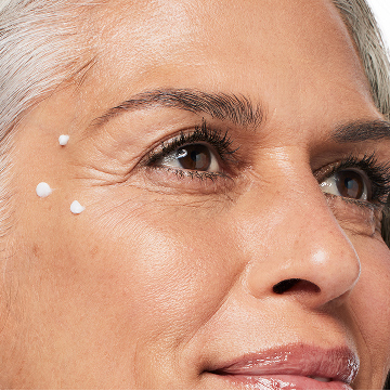Woman with three dots of Mary Kay Clinical Solutions Dynamic Wrinkle Limiter near her crows feet